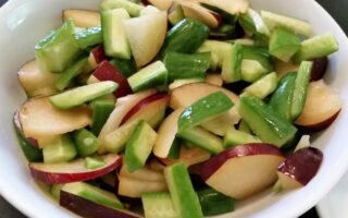 Choped plum and cucumbers tossed together in a bowl