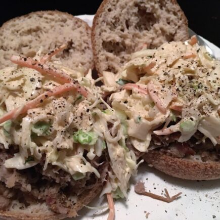Low Carb Coleslaw served on low carb english muffins on white paper plate